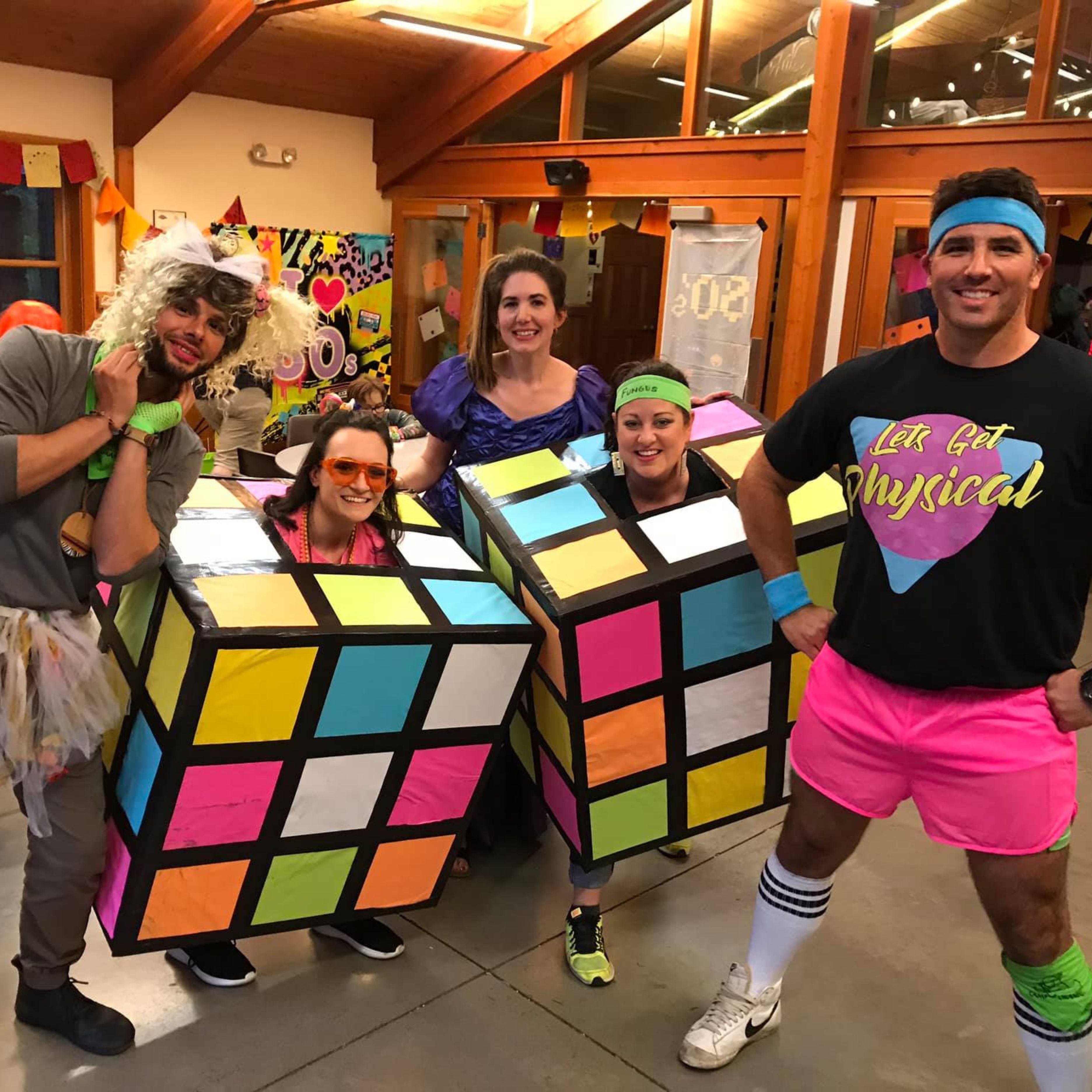 group of volunteers dressed up for 80s theme